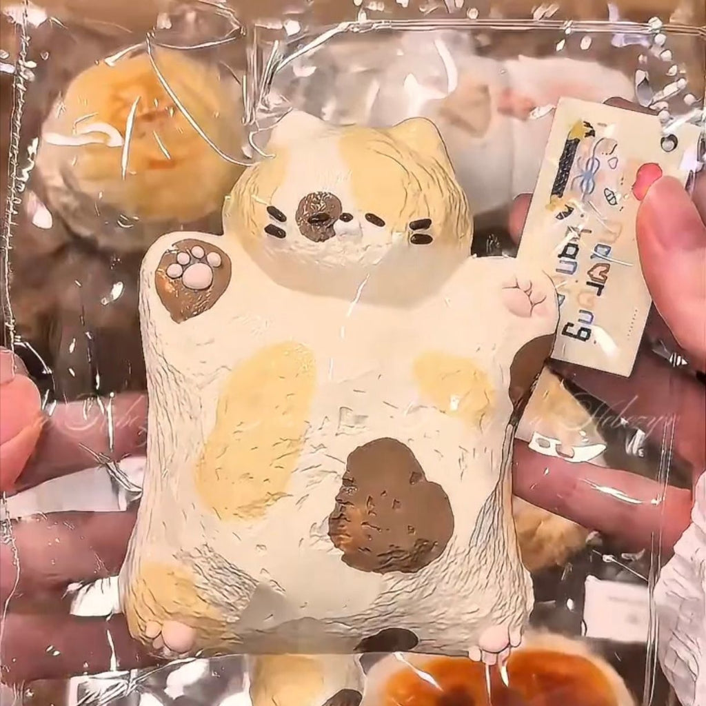 Cream Squishy Tabby Cat toy held in hand for scale