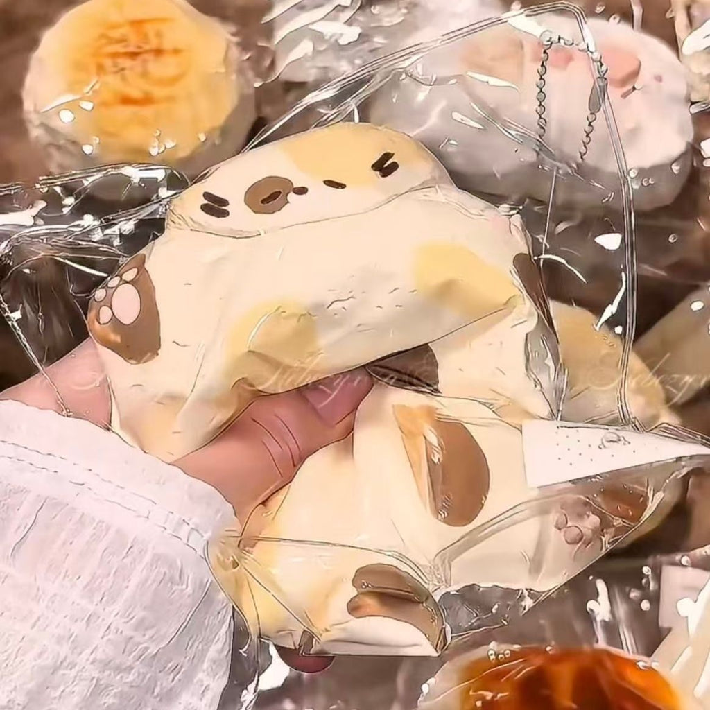 Cream Squishy Tabby Cat toy being squeezed, showing slow-rebound texture