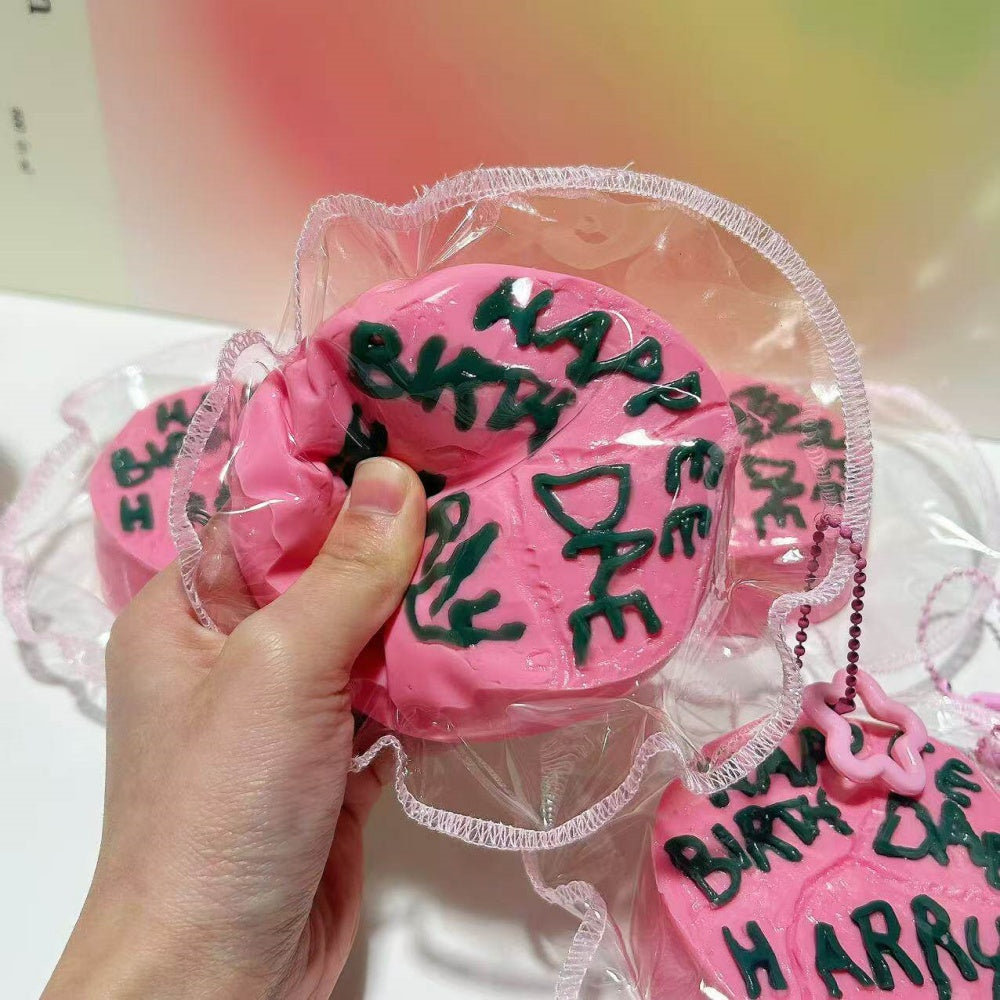 Happee Birthdae Cake squishy toy, side angle view