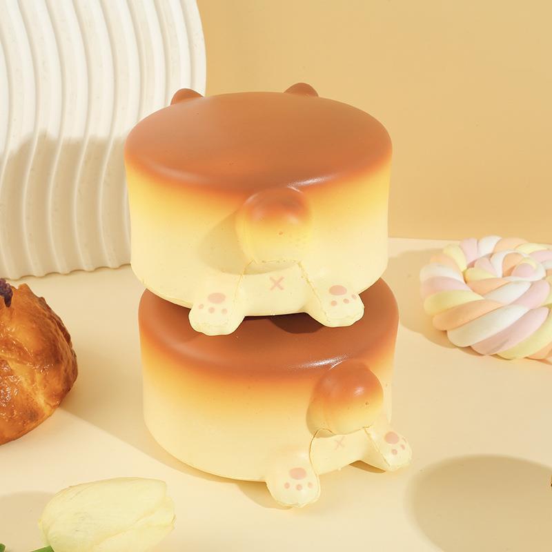 Slow Rise Cheese Cake Dog squishy toy held in hand for scale