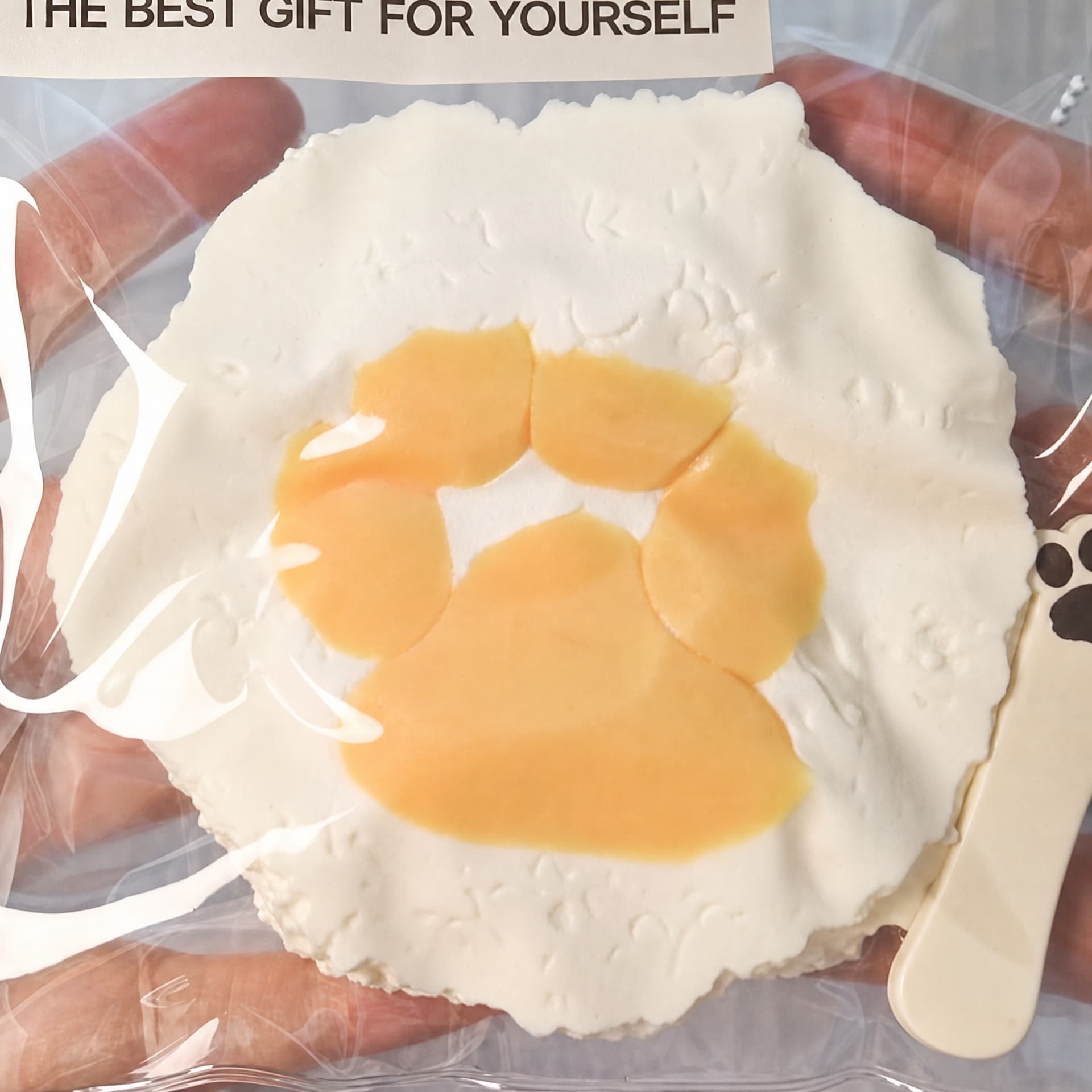 Squishy Rice Cat Paw Taba toy, cream color, back view