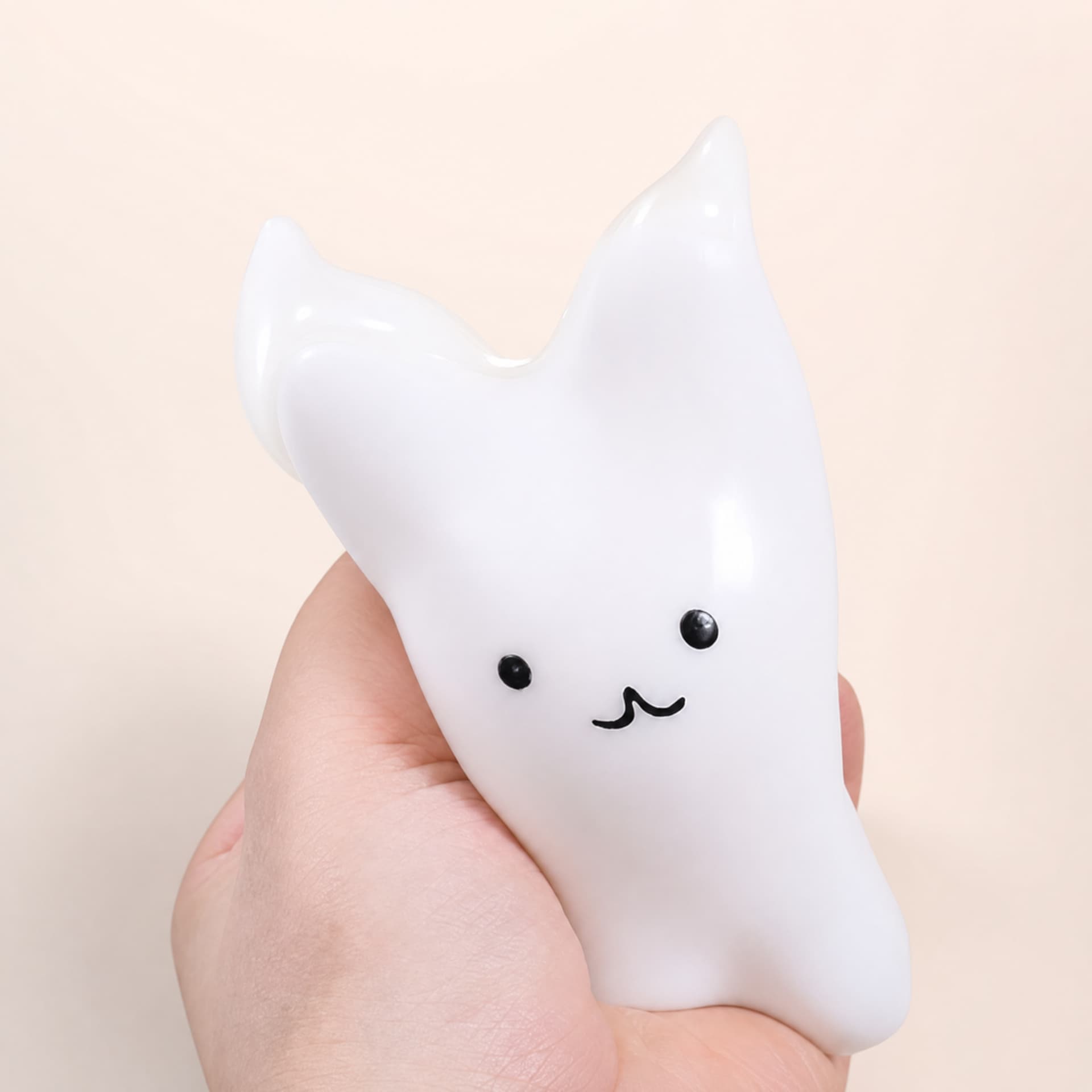 Cat & Bunny Custard Pinch toy, bunny design, held in hand