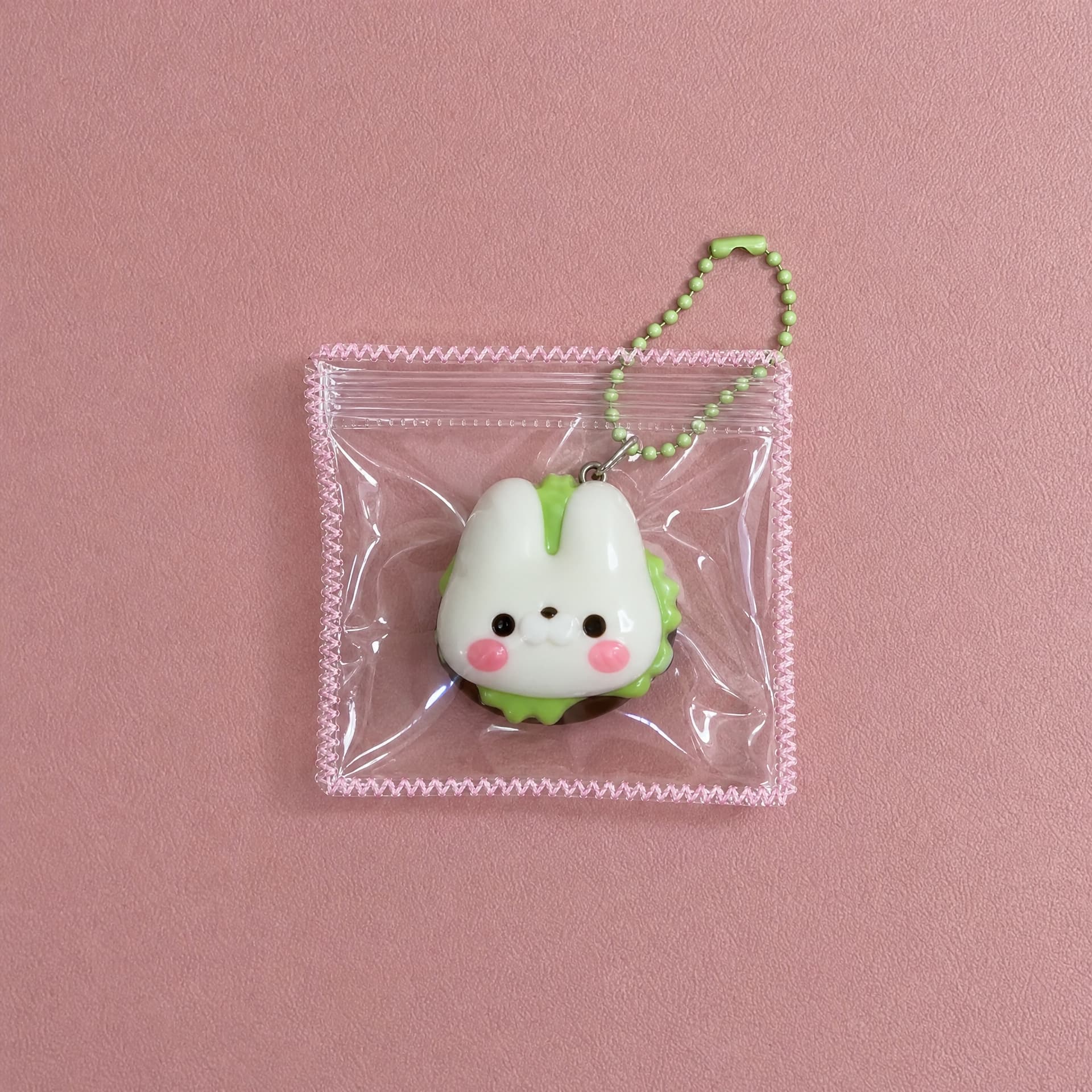 Lil Mini Squeeze Charm, bunny design on pink background