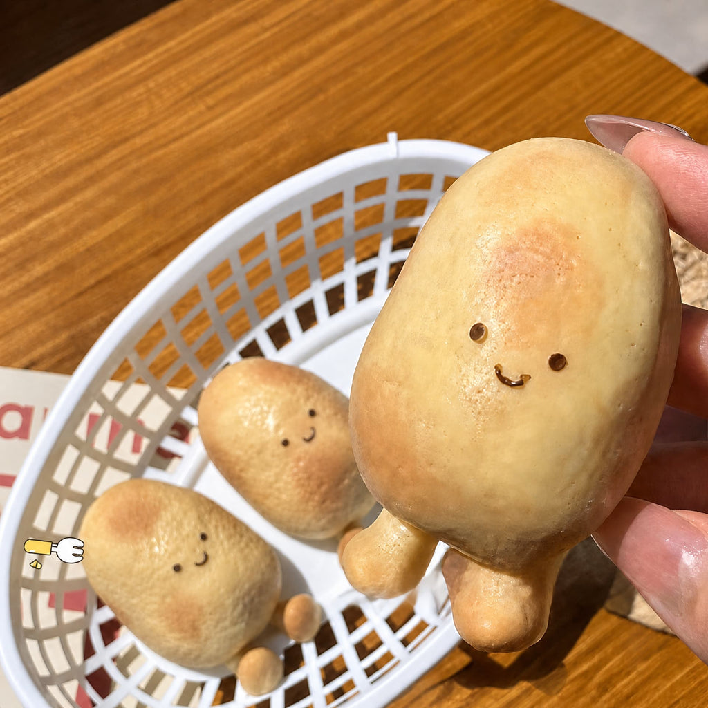 Pinch Potato squishy toy held in hand for scale