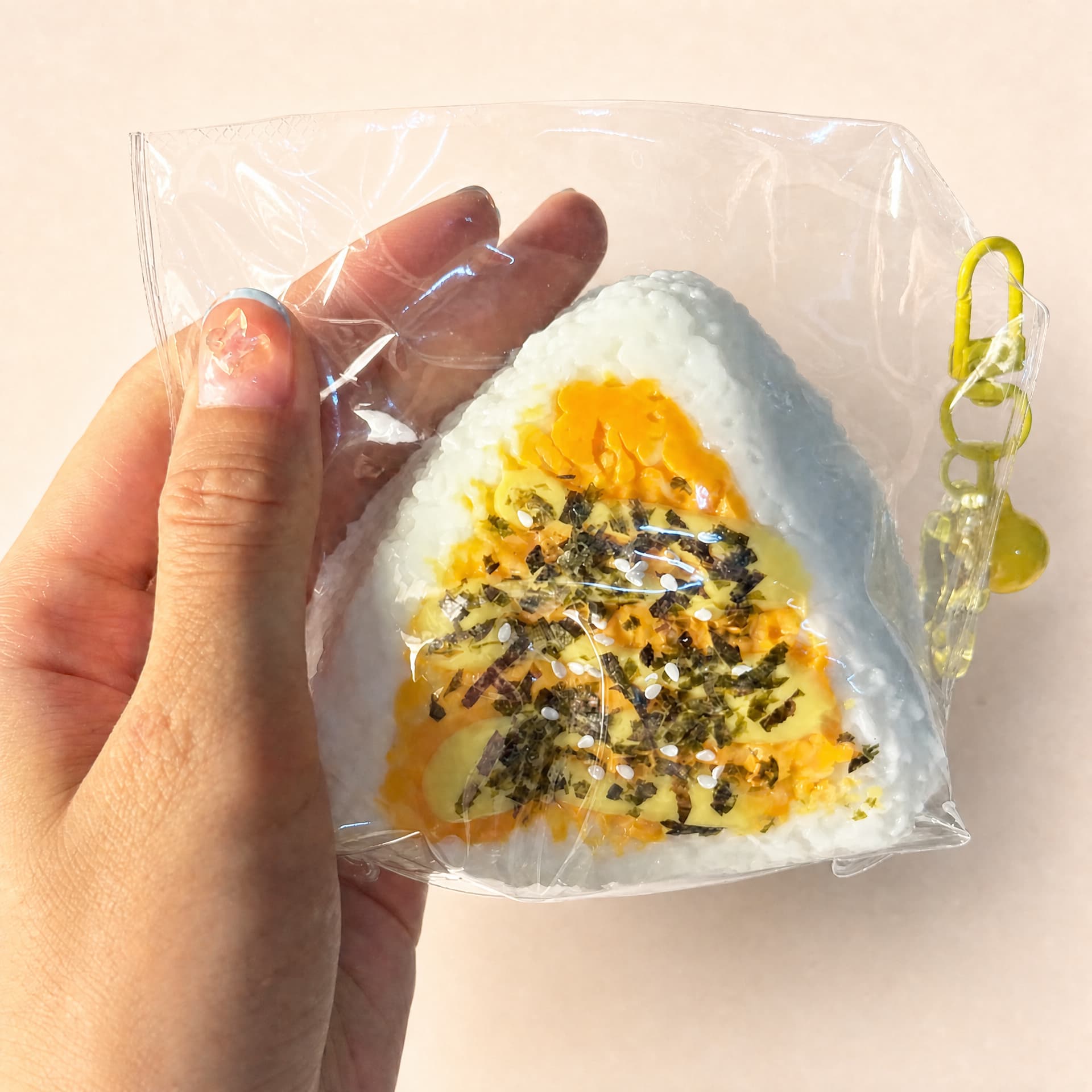 Ultra-slow Rebound Onigiri Taba rice ball squishy toy held in hand for scale