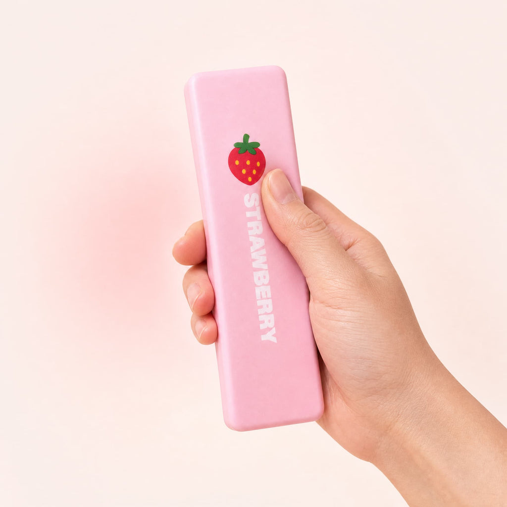 Slow Rise Butter Sticks squishy toy, strawberry cream flavor, held in one hand being squeezed